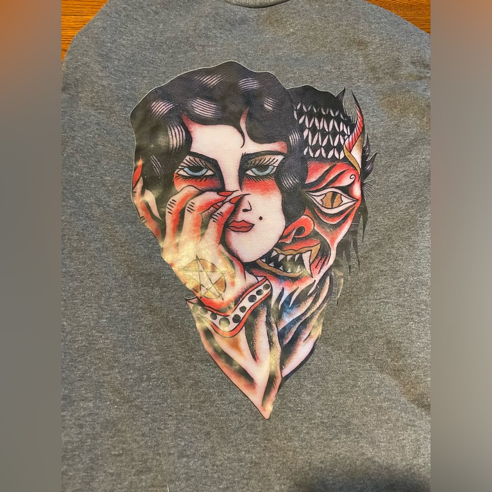 Men’s - grey crewneck sweatshirt with appliqué design on back. NEW without tag.